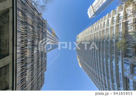 Looking up at residential buildings in Austin Texas against vibrant blue sky 94165955