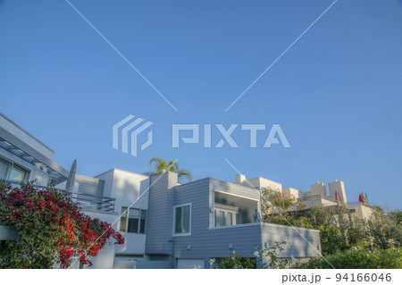 Houses with gray and white exterior wall against blue sky at Del Mar California 94166046