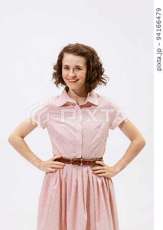 Portrait of young beautiful woman posing, looking at camera and smiling isolated over white background Portrait of young beautiful woman posing, looking at camera and smiling isolated over white background 94166479