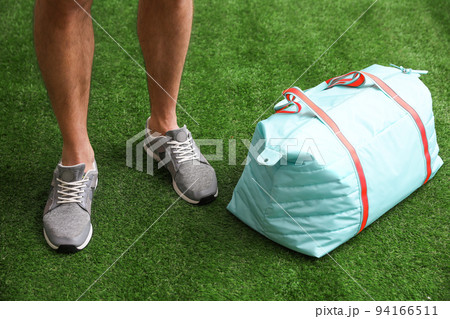 Man standing with sports bag, closeup view 94166511