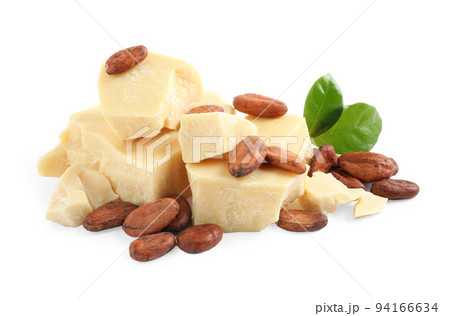 Organic cocoa butter, beans and green leaves isolated on white 94166634