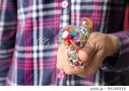 Woman squeezing colorful slime, closeup. Antistress toy Woman squeezing colorful slime, closeup. Antistress toy 94166938