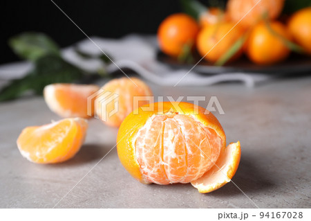 Fresh ripe tangerine on light grey table Fresh ripe tangerine on light grey table 94167028