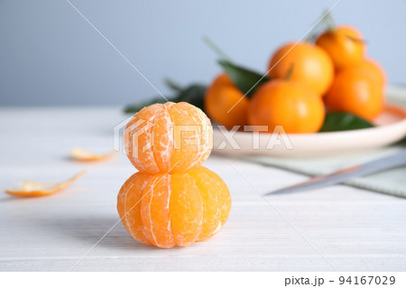 Peeled ripe tangerines on white wooden table. Space for text Peeled ripe tangerines on white wooden table. Space for text 94167029