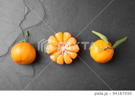Fresh ripe tangerines on dark grey table, flat lay 94167030