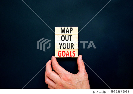 Support and map out your goals symbol. Concept words Map out your goals on wooden blocks on beautiful black table black background. Businessman hand. Business, support and map out your goals concept Support and map out your goals symbol. Concept words Map out your goals on wooden blocks on beautiful black table black background. Businessman hand. Business, support and map out your goals concept 94167643