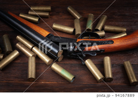 Vintage retro shotgun with brass cartridges Vintage retro shotgun with brass cartridges 94167889