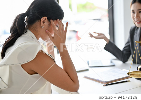 Stressed Asian female client in the meeting with her personal female lawyer Stressed Asian female client in the meeting with her personal female lawyer 94173128