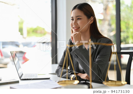 Professional Asian female lawyer or business legal consultant sits at her office desk Professional Asian female lawyer or business legal consultant sits at her office desk 94173130