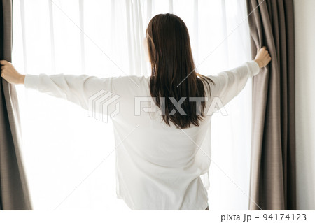 カーテンを開ける女性・起床イメージ カーテンを開ける女性・起床イメージ 94174123