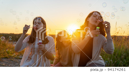 Happy family at sunset 94174261