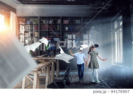 Kids wearing virtual reality goggles 94176907