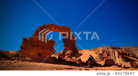 Arch Rock formation aka Arch of Africa or Arch of Algeria with moon at Tamezguida in Tassili nAjjer national park in Algeria 94178647
