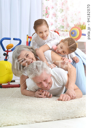 Grandfather and grandmother together with their granddaughters are training Grandfather and grandmother together with their granddaughters are training 94182070
