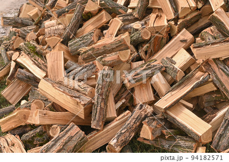 Pile of firewood logs. Firewood background. Winter preparation. Firewood background. selective focus. 94182571