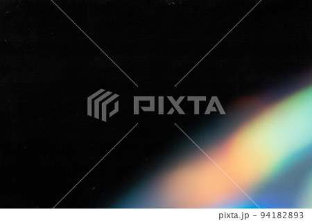 colorful warm rainbow light leaks on black background with dust texture 94182893
