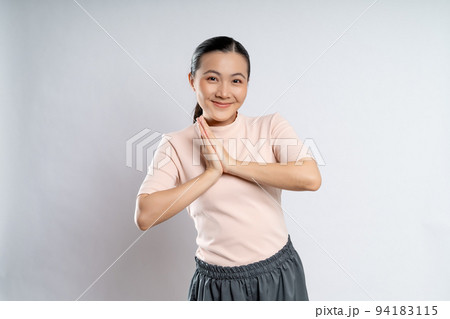 Asian woman guilty holding hands in prayer isolated on background. 94183115