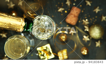 Champagne pouring in a glass from a bottle, top view. 94183643