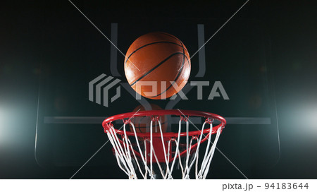 Detail of basketball ball hitting the basket. 94183644