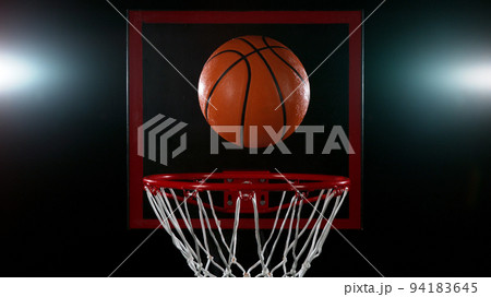 Detail of basketball ball hitting the basket. 94183645