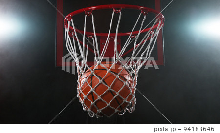 Detail of basketball ball hitting the basket. 94183646