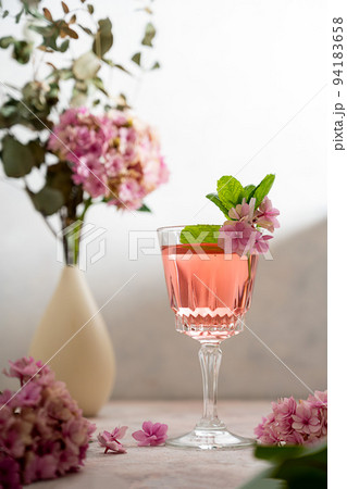 Pink drink cocktails, liquor or gin. Pink sangria fruity wine with hydrangea pink flowers. Bright, girly background Pink drink cocktails, liquor or gin. Pink sangria fruity wine with hydrangea pink flowers. Bright, girly background 94183658