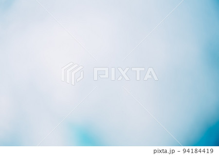 Light flare background. Blur glow. Bokeh radiance. Defocused blue white color gradient smooth glare spots abstract copy space texture. Light flare background. Blur glow. Bokeh radiance. Defocused blue white color gradient smooth glare spots abstract copy space texture. 94184419