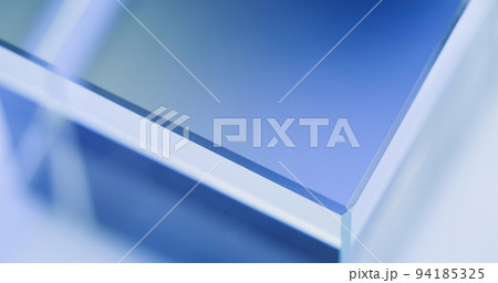 Neon illuminated background. Blur light. Glass cube angle. Defocused tranquil blue white color glow modern geometric abstract empty space poster for text. 94185325