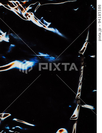 Aged film overlay. Dust scratches texture. Weathered surface. Blue orange white glow grain noise on dark black worn faded abstract illustration background. 94185386