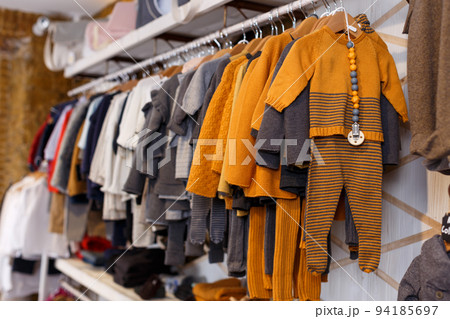 Stand with many baby costumes 94185697