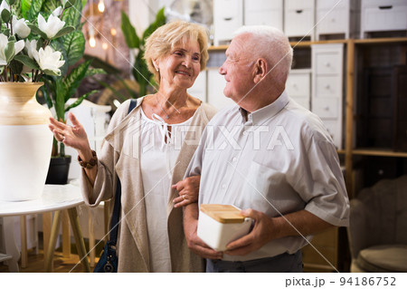 Mature couple with various goods in a shop Mature couple with various goods in a shop 94186752