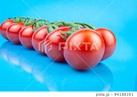 cherry tomatoes on blue background 94188161