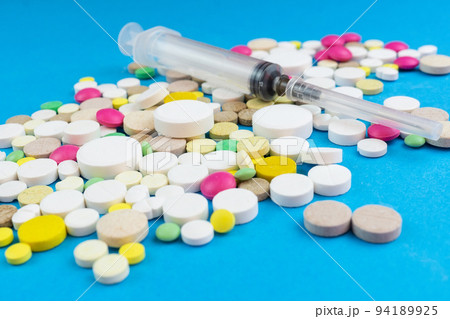 pills on a blue background pills on a blue background 94189925