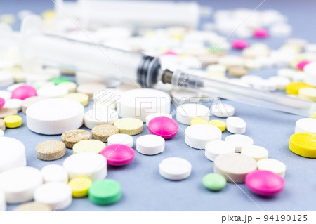 pills on a blue background pills on a blue background 94190125