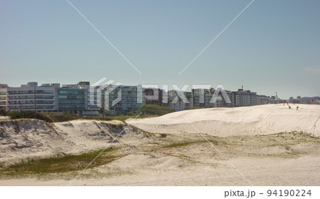 Sand dunes and beachfront buildings at Forte beach. Cabo Frio, Rio de Janeiro, Brazil 94190224