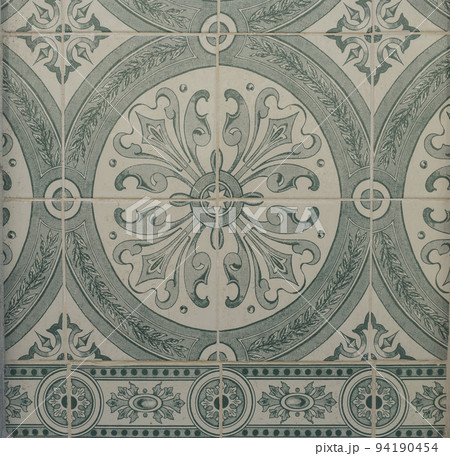 Green ceramic tiles from facade of old houses in Lisbon Portugal. Portuguese traditional Azulejos decorative artistic design background, creative texture surface Green ceramic tiles from facade of old houses in Lisbon Portugal. Portuguese traditional Azulejos decorative artistic design background, creative texture surface 94190454