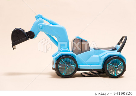 Blue excavator plastic machine on white background. Construction machinery car for digging for toy store and children. Blue excavator plastic machine on white background. Construction machinery car for digging for toy store and children. 94190820