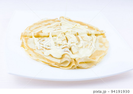 Pancakes drenched with condensed milk 94191930