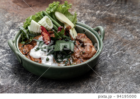 Traditional stir fried spicy Asian Redtail Catfish (Hemibagrus wyckioides) or Kang catfish with red curry paste. 94195000