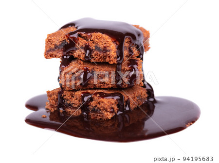 Pieces of brownie cake isolated on white background. Cake with dark chocolate syrup. Pieces of brownie cake isolated on white background. Cake with dark chocolate syrup. 94195683