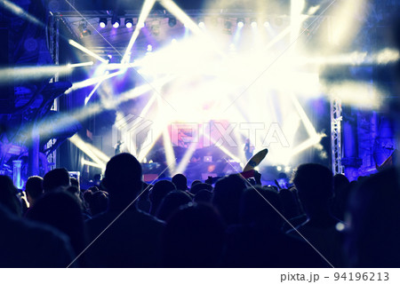 Crowd rocking during a concert with raised arms. Crowd rocking during a concert with raised arms. 94196213
