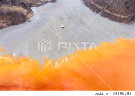 Aerial view of a submerged church in contaminated lake 94196293