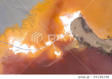 Aerial view of a mining decanting pond with toxic red residuals Aerial view of a mining decanting pond with toxic red residuals 94196296