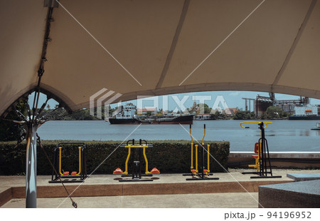 Various types of exercise equipment in the private park of condominium along the Chao phraya river. 94196952