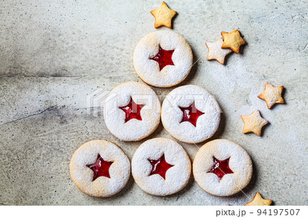 Christmas tree from strawberry linzer cookies on gray background. Festive dessert, winter treat. 94197507