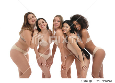Group of women with different body types in jeans and underwear taking selfie against light Group of women with different body types in jeans and underwear taking selfie against light 94199898