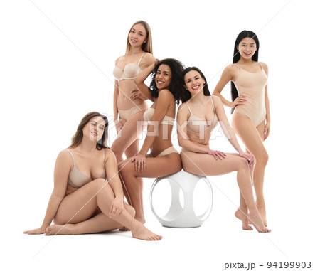 Group of women with different body types in jeans and underwear taking selfie against light  94199903