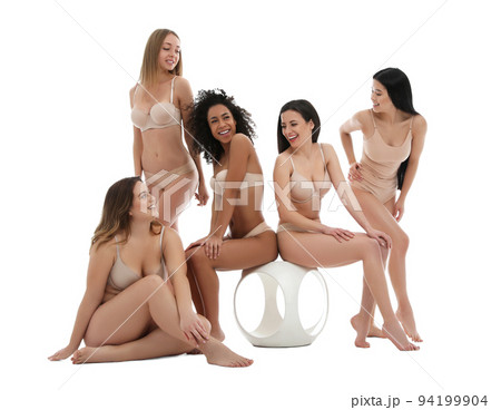 Group of women with different body types in jeans and underwear taking selfie against light Group of women with different body types in jeans and underwear taking selfie against light 94199904