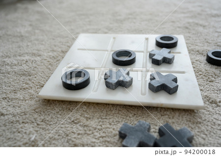 Marble Tic Tac Toe or OX board game on soft carpet with copy space. concept of strategy, risk, competition in business. Marble Tic Tac Toe or OX board game on soft carpet with copy space. concept of strategy, risk, competition in business. 94200018