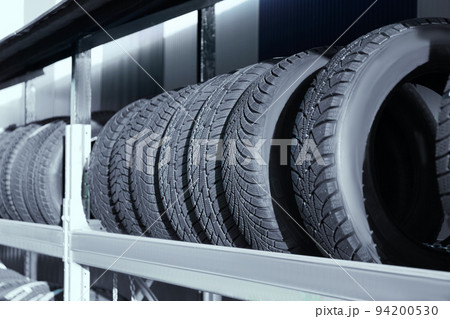 Tires on rack in car service workshop 94200530